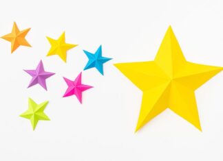 How to Make a Paper Star A large yellow paper star beside a group of small, colourful paper stars