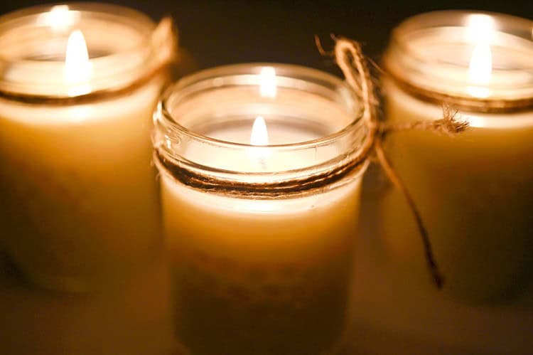 Lit mason jar candles decorated with twine
