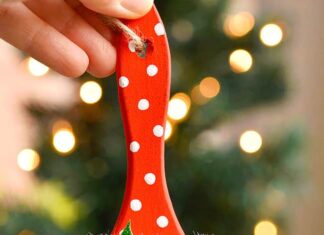 How to make Paint Brush Santa Paint brush Santa ornament held in front of a Christmas tree