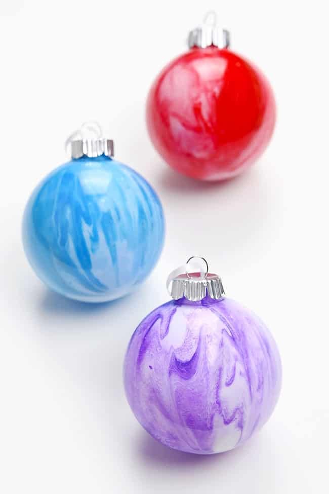 Colourful paint pouring ornaments on a white background