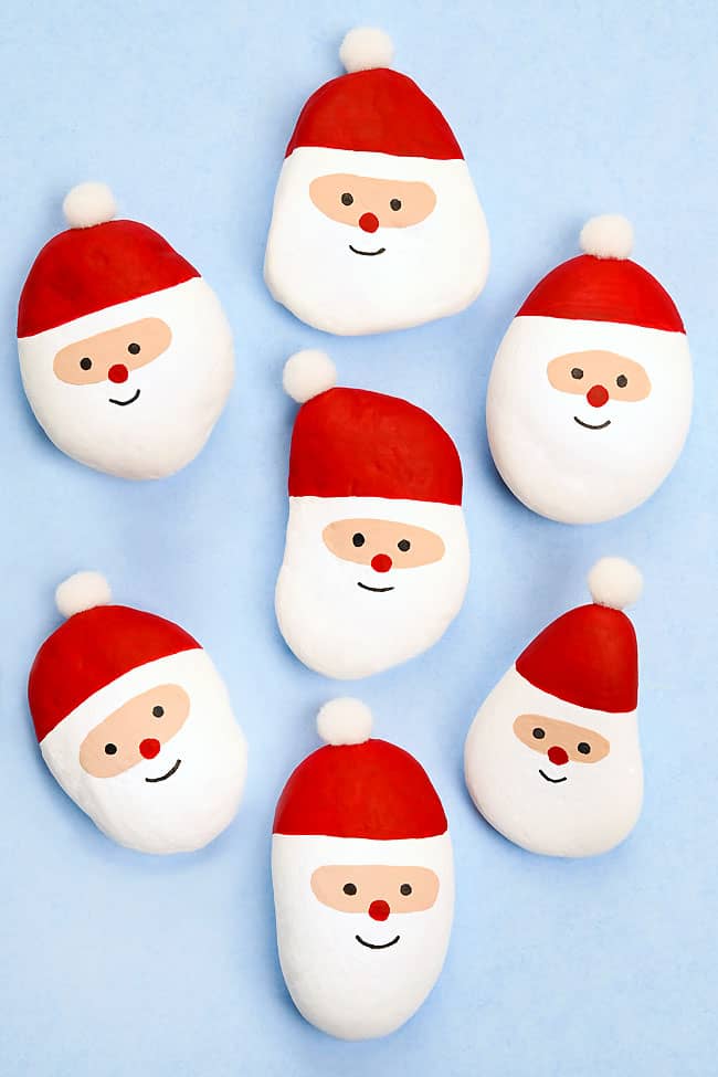Painted Santa Rocks Group of painted Santa rocks on a blue background