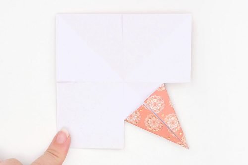 Square paper folded to create a point in one corner