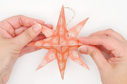 Hands holding 2 paper stars together