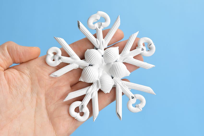 Pasta Christmas ornament held in a hand