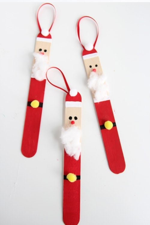 Create a DIY santa ornament out of popsicle sticks. These are SO CUTE and super easy to make!