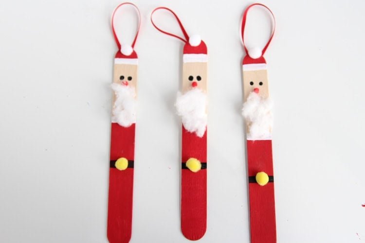 Create a DIY santa ornament out of popsicle sticks. These are SO CUTE and super easy to make!