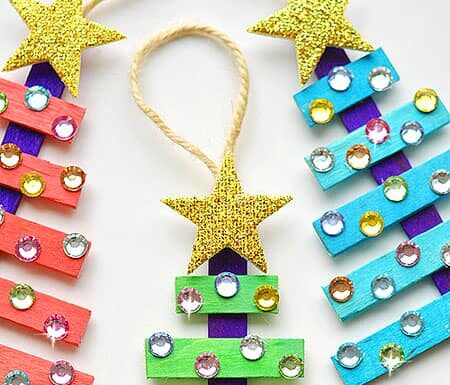 Glittering Popsicle Stick Christmas Trees These popsicle stick Christmas trees are SO EASY to make and they're so beautiful! The kids loved decorating them! Such an awesome dollar store Christmas craft idea!!