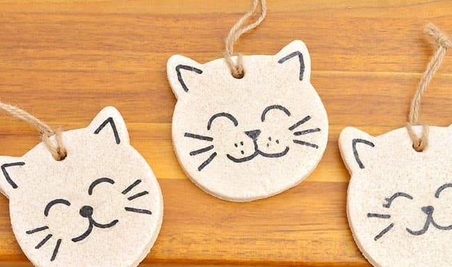 How to make Salt Dough Cat Ornaments Painted salt dough cat ornaments on a wooden surface