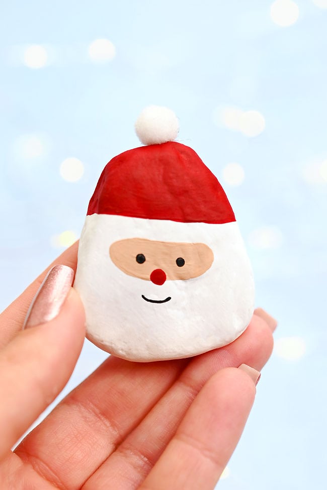 Santa Claus Painted Rocks Holding a Santa painted rock