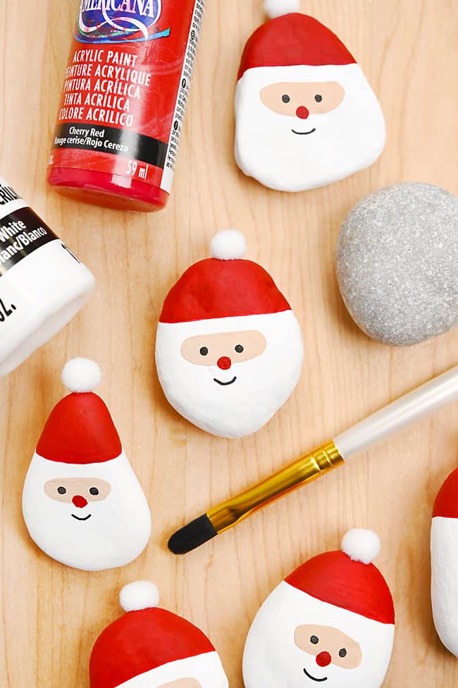 Santa Painted Rocks Santa painted rocks with paint bottles and paint brush