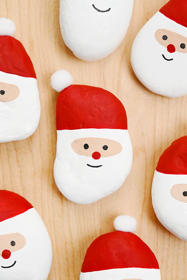 Santa Rocks Painted Santa rocks on a wood background