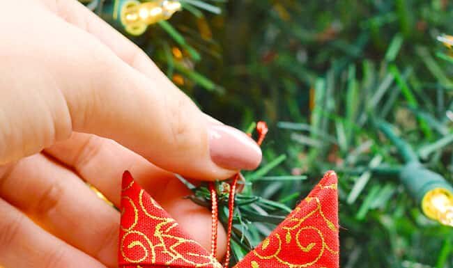 How to Make a Folded Fabric Star Ornament Scandinavian star ornament in front of a Christmas tree